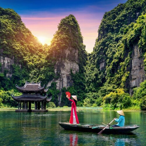 Asian woman wearing Vietnam culture traditional at Trang An, Vietnam.